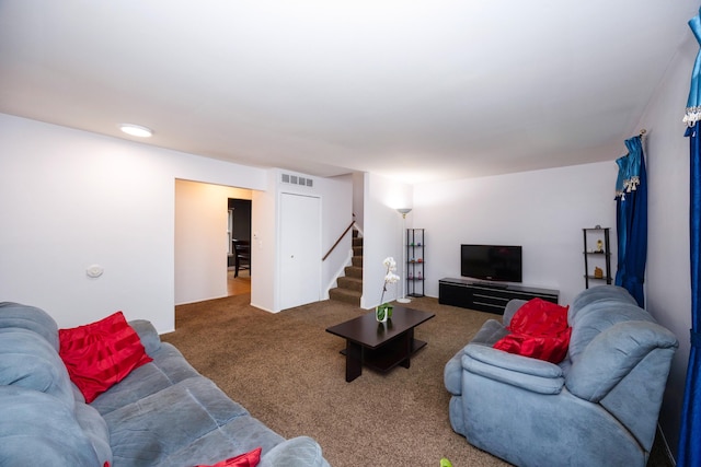 carpeted living room with visible vents and stairway