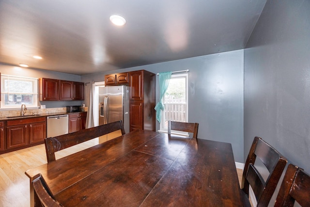 unfurnished dining area with light wood-type flooring and a sink