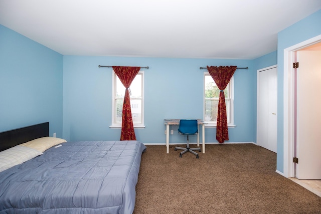 carpeted bedroom featuring baseboards