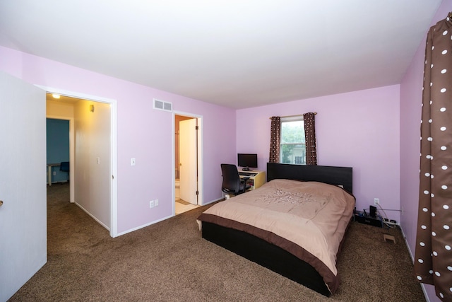 bedroom with carpet floors, baseboards, visible vents, and ensuite bathroom