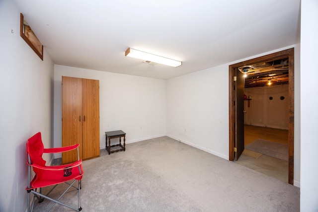 misc room featuring light colored carpet and baseboards