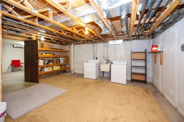 unfinished basement featuring a sink and washer and dryer