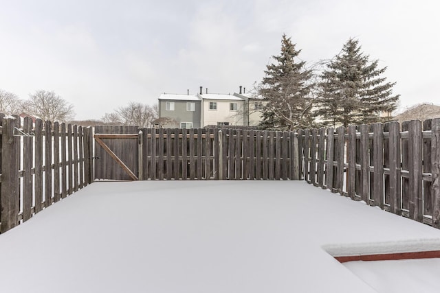 yard layered in snow with fence