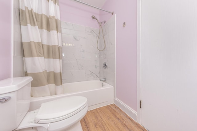 bathroom featuring shower / bath combination with curtain, toilet, and wood finished floors