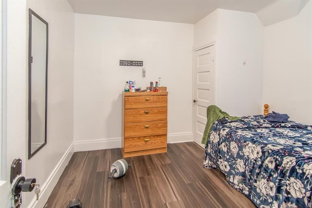 bedroom featuring dark wood-style floors and baseboards