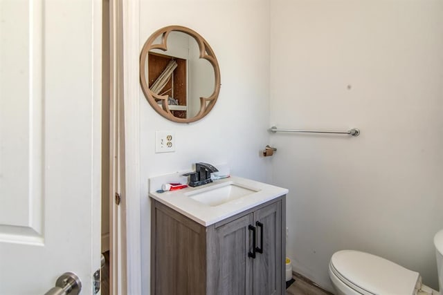 bathroom with toilet and vanity