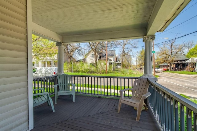 wooden terrace featuring covered porch and a residential view