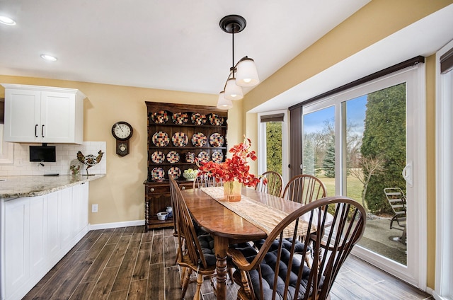 dining space with recessed lighting, dark wood finished floors, and baseboards