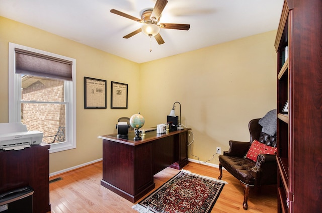 office area with ceiling fan, baseboards, visible vents, and light wood-style floors