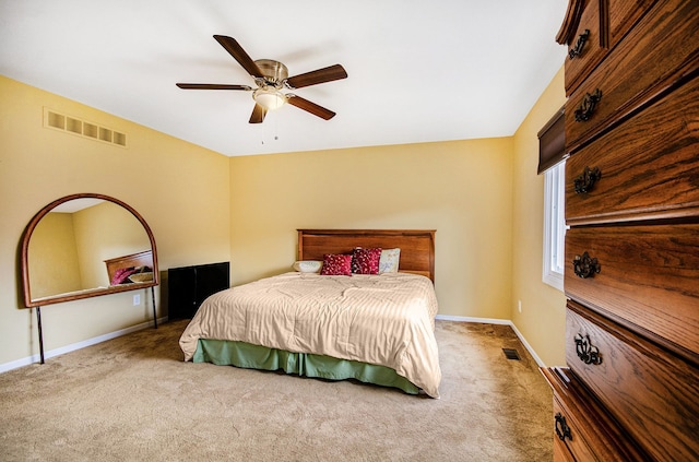 carpeted bedroom featuring baseboards, visible vents, and ceiling fan