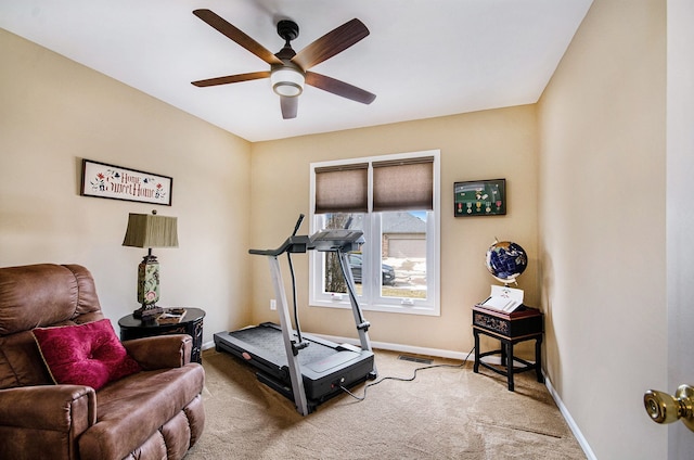 exercise room featuring light colored carpet, ceiling fan, visible vents, and baseboards