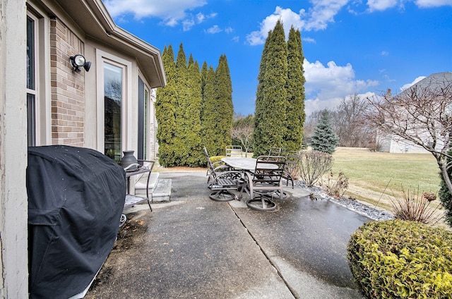 view of patio featuring outdoor dining area and a grill