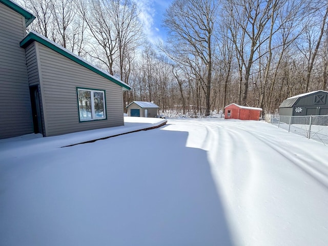 yard layered in snow with fence