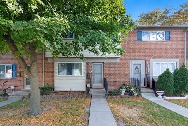 townhome / multi-family property featuring brick siding