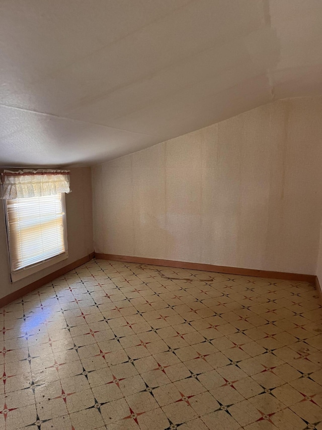 unfurnished room with baseboards and light floors