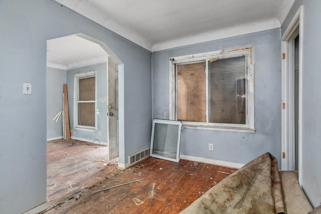 spare room featuring visible vents and arched walkways