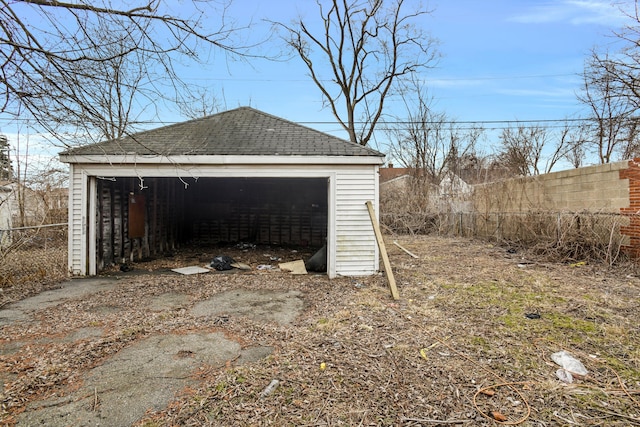 detached garage featuring fence