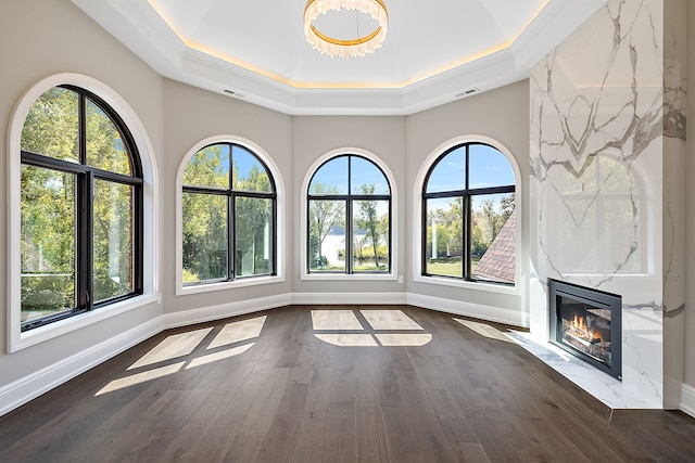 interior space featuring dark wood-style floors, a high end fireplace, and visible vents