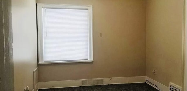 empty room featuring visible vents and baseboards