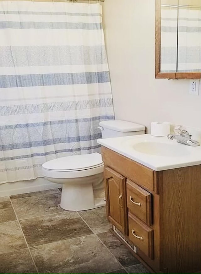 bathroom featuring toilet, stone tile flooring, vanity, and shower / bathtub combination with curtain