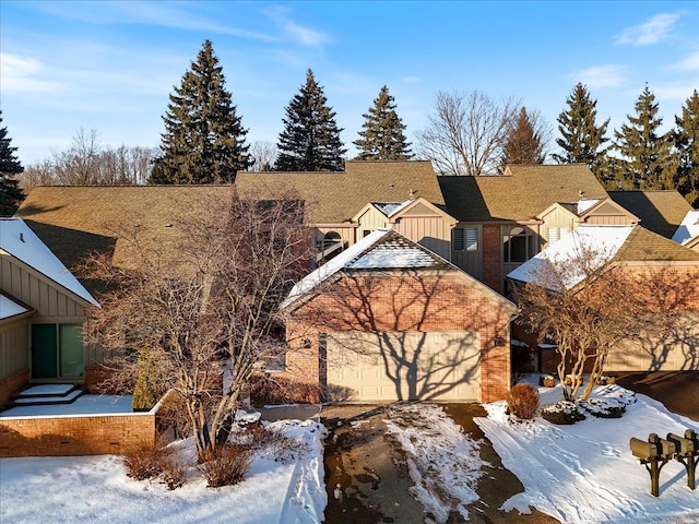 exterior space featuring brick siding, board and batten siding, a shingled roof, and a residential view