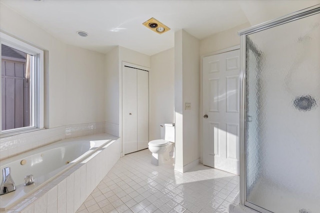 bathroom with tile patterned flooring, toilet, a closet, a shower stall, and a whirlpool tub