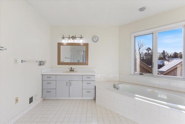 full bathroom featuring tile patterned flooring, visible vents, a bath, and vanity