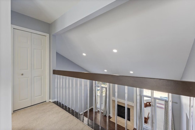 corridor with lofted ceiling and recessed lighting