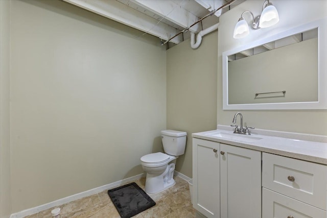 half bath with vanity, toilet, and baseboards