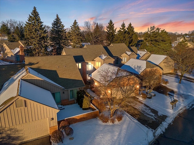 aerial view at dusk featuring a residential view