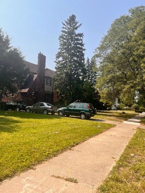 exterior space with a chimney and a yard