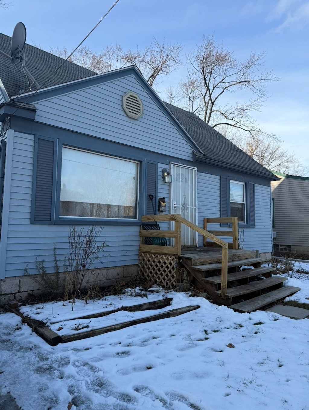 view of front of home with a garage and a shingled roof