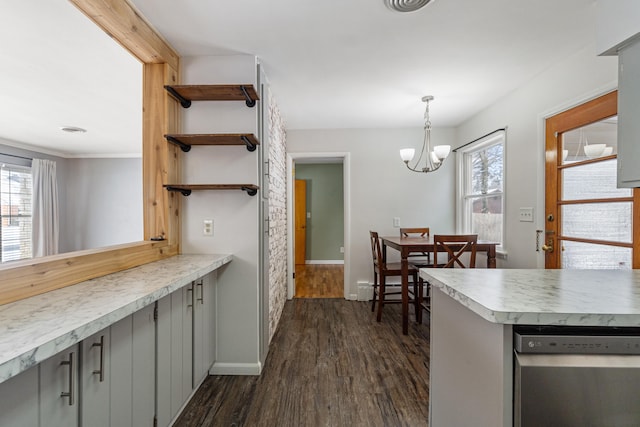 kitchen featuring dark wood-style floors, decorative light fixtures, light countertops, gray cabinetry, and open shelves