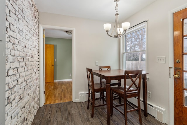 dining space featuring dark wood-style floors, baseboards, a notable chandelier, and baseboard heating