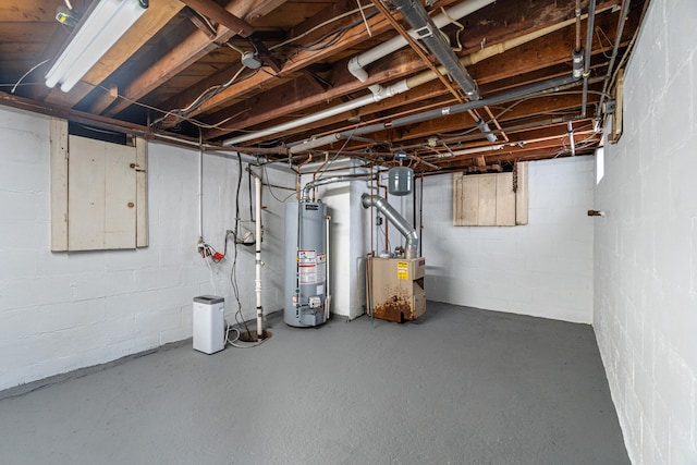 unfinished basement with water heater and a heating unit