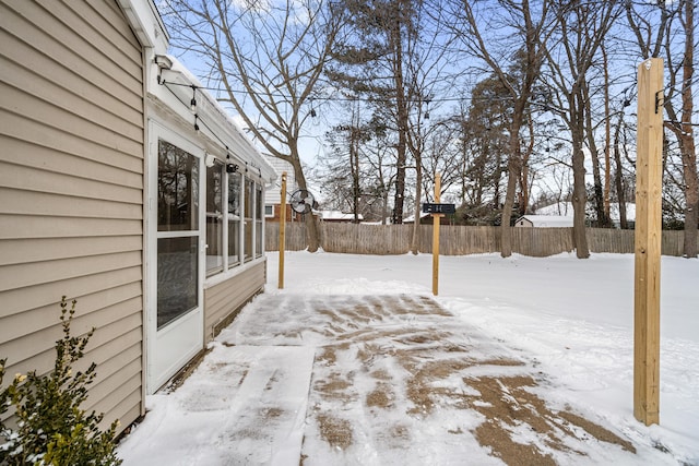 yard covered in snow with fence