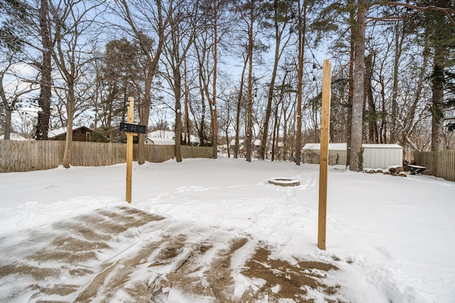 yard covered in snow with fence