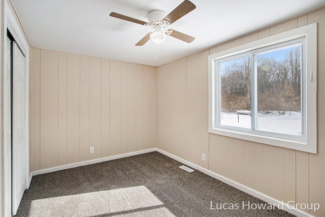 unfurnished bedroom with carpet, a closet, visible vents, ceiling fan, and baseboards