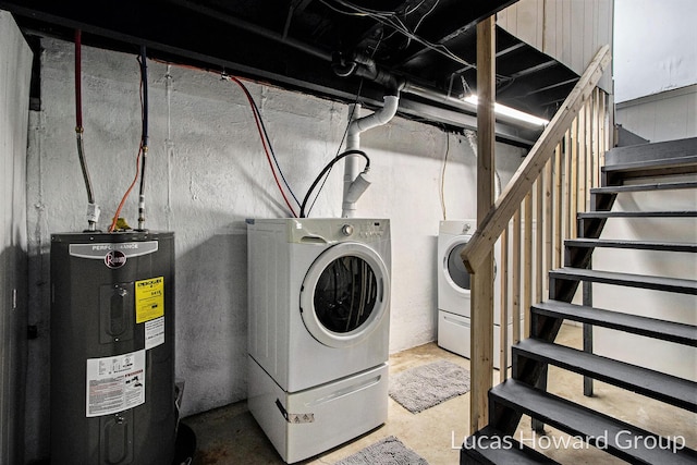 laundry area with water heater, laundry area, and washer and dryer