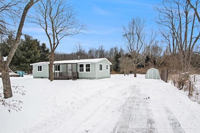 manufactured / mobile home featuring a storage shed and an outbuilding