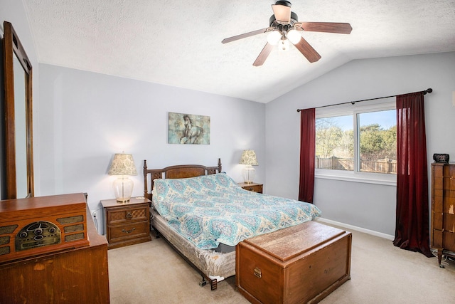 bedroom featuring lofted ceiling, light carpet, and a textured ceiling