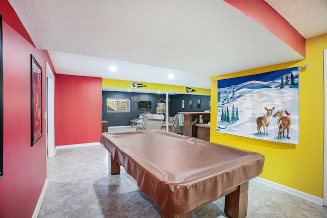 recreation room with billiards, a textured ceiling, and baseboards