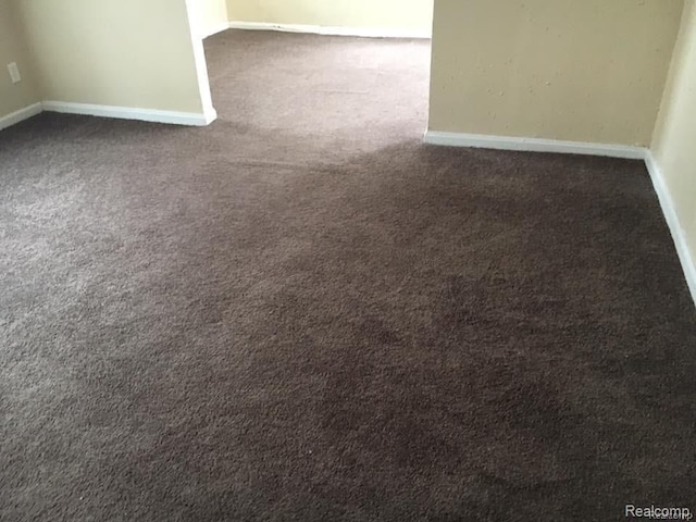 interior space with carpet floors and baseboards