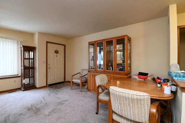 dining area with light colored carpet, visible vents, and baseboards