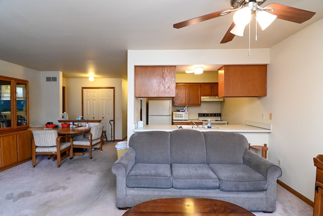 living area featuring light carpet, ceiling fan, visible vents, and baseboards