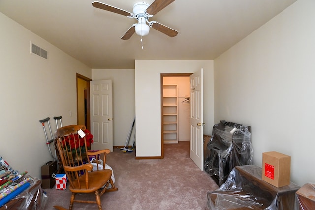 interior space with light carpet, baseboards, visible vents, and a ceiling fan