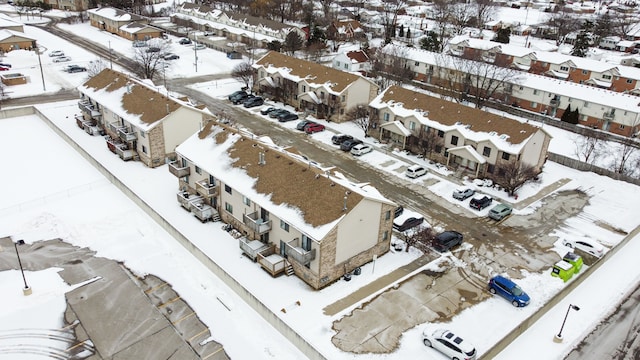 snowy aerial view with a residential view