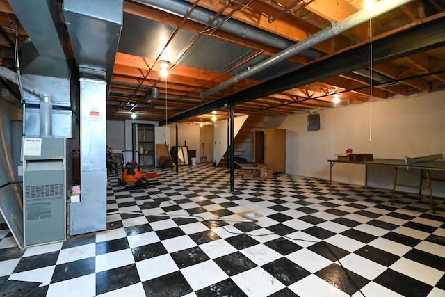 basement featuring heating unit and dark floors