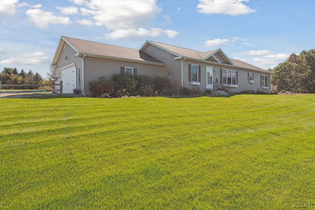 ranch-style house featuring a front lawn and an attached garage