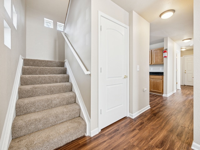 stairs featuring baseboards and wood finished floors